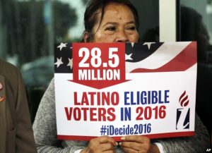 Georgina Arcienegas holds a sign in support of Latino voters in Florida earlier this year. PHOTO: VOA news)