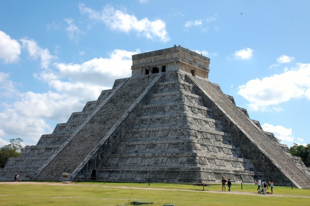 tourist walking beside a pyramid